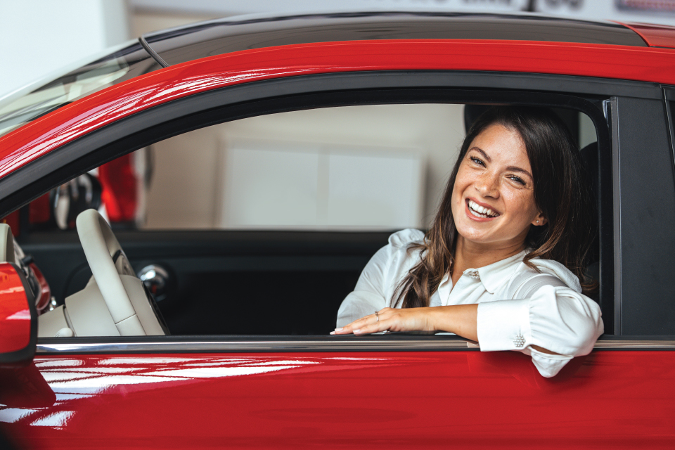 woman-in-red-car-smiling